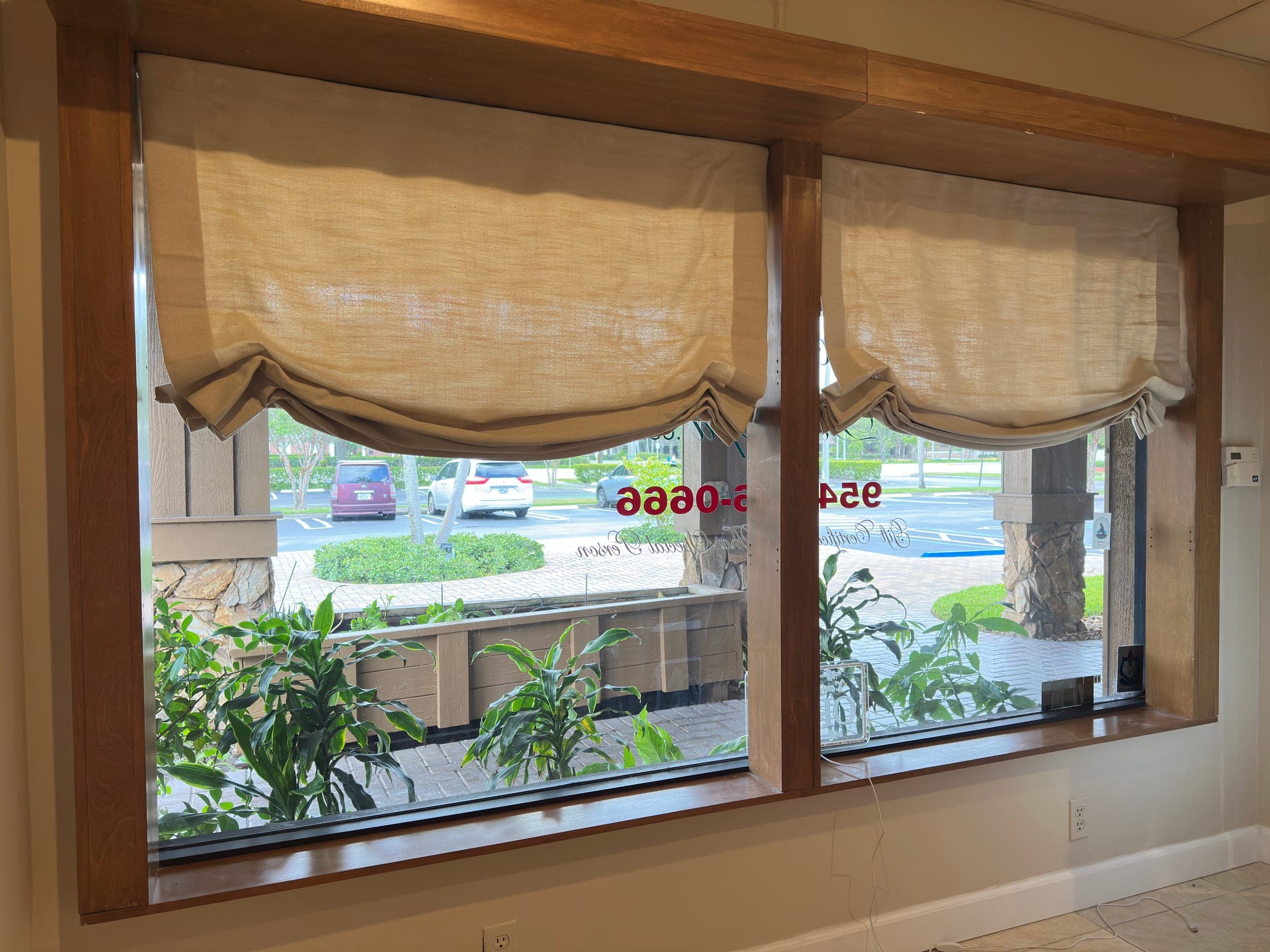 Commercial roman shades installed in a Coral Springs storefront window