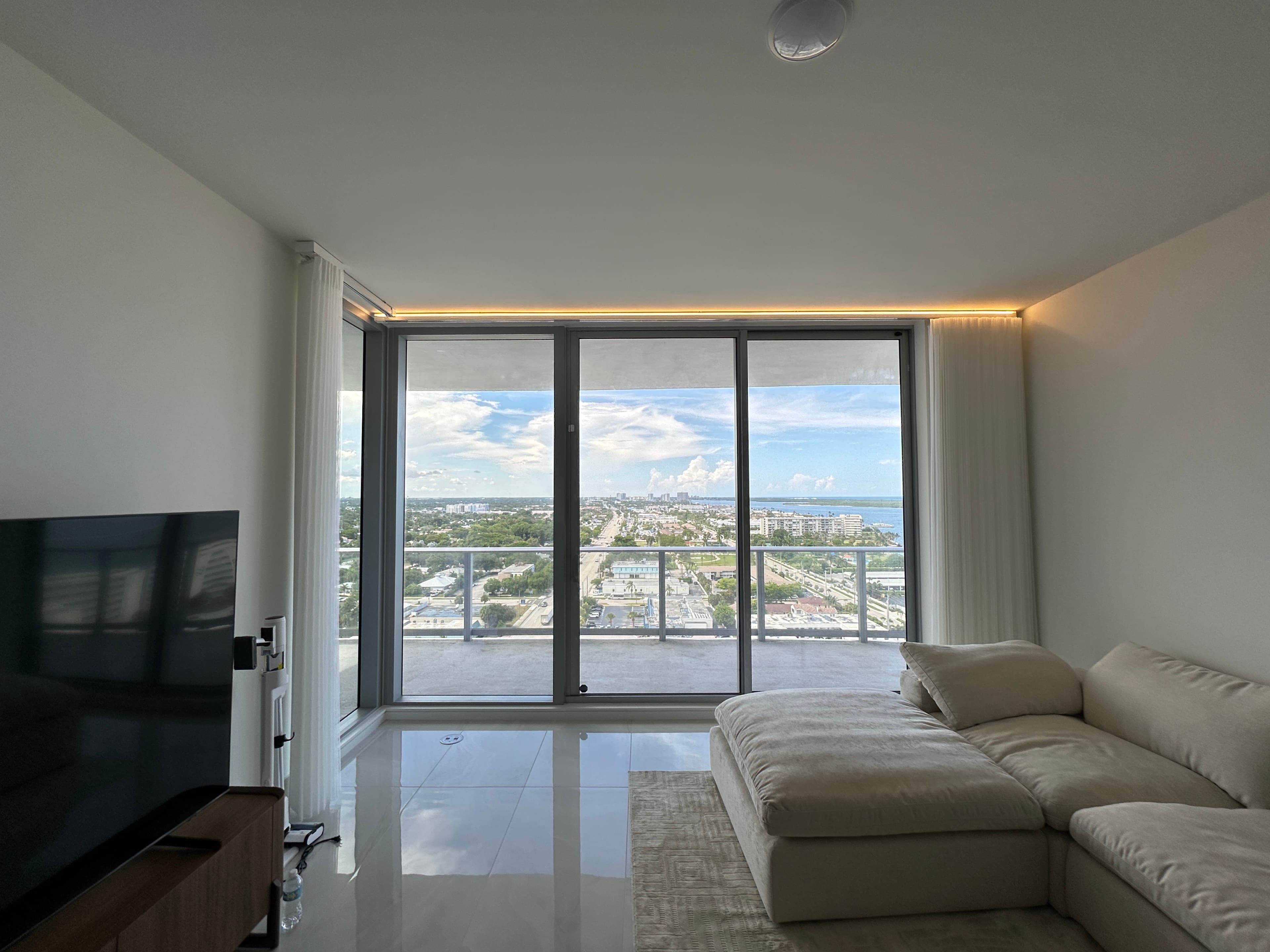 Open Dream Sheer panels framing a Lake Park high-rise balcony view